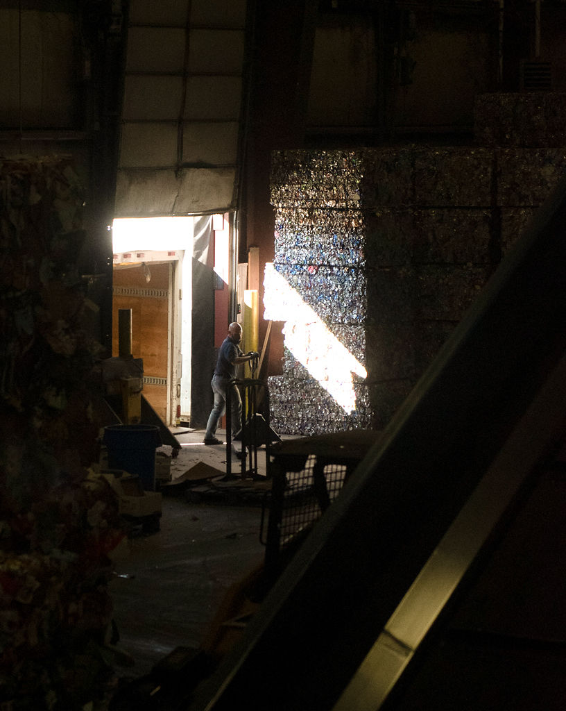 Tom Elliott loads bales of recycled materials